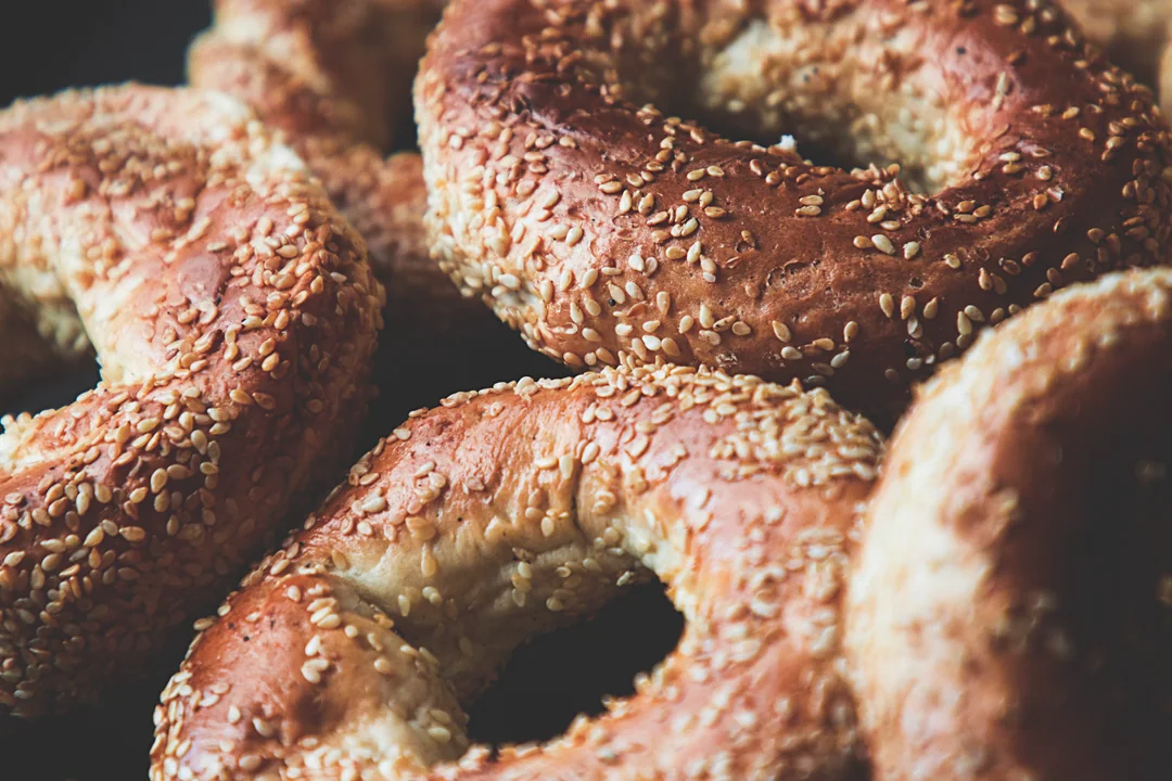 Sesame bagels piled up, close up